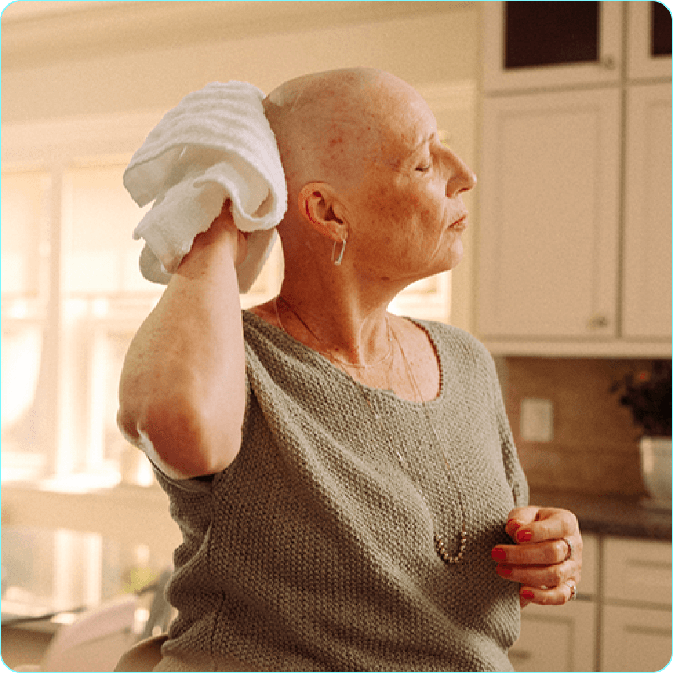 Danile drying her scalp with a towel.