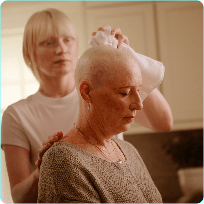 Danile's daughter dries her scalp with a cloth.